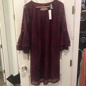 Maroon pattern dress with flowing sleeves.